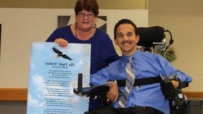 Garrett Putnam with Mary Westgate, Polk State's disability services coordinator. Westgate presented Putnam with a laminated version of his poem, "The Fight Within," during last month's Criminal Justice Teach-In.